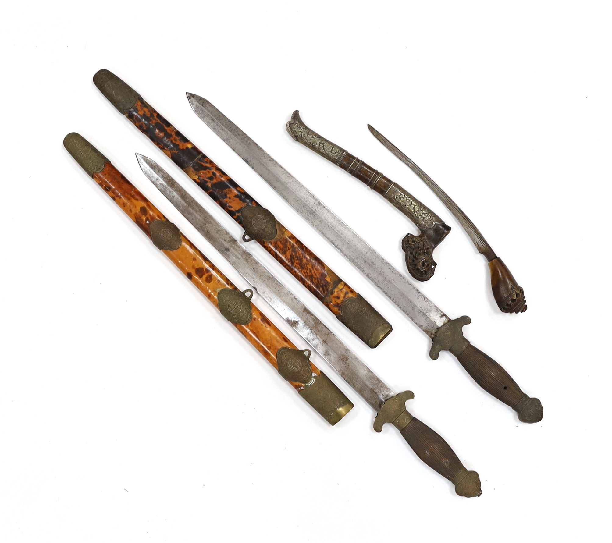 Two Chinese short swords (Jian) in faux tortoiseshell veneered scabbards and a Sumatran knife dagger with sheath (sekin), blade 42cm